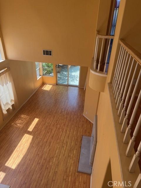 330 E Concord Way, Placentia, CA 92870 - unfurnished living room featuring wood finished floors, a towering ceiling, and stairs