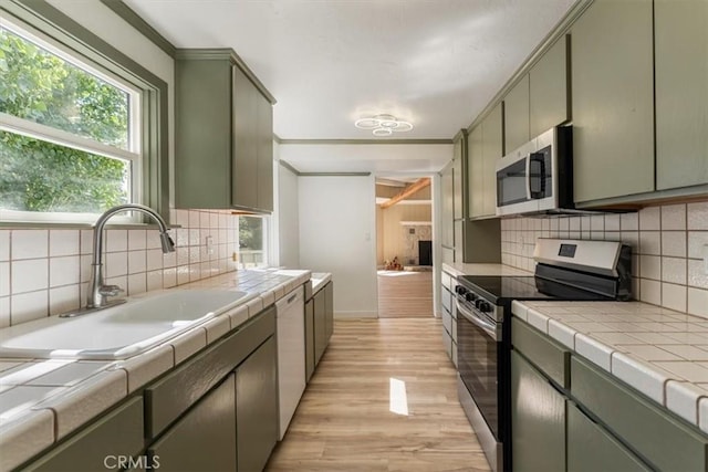 1212 N Old Stage Rd, Mount Shasta, CA 96067 - kitchen featuring appliances with stainless steel finishes, tile counters, and backsplash