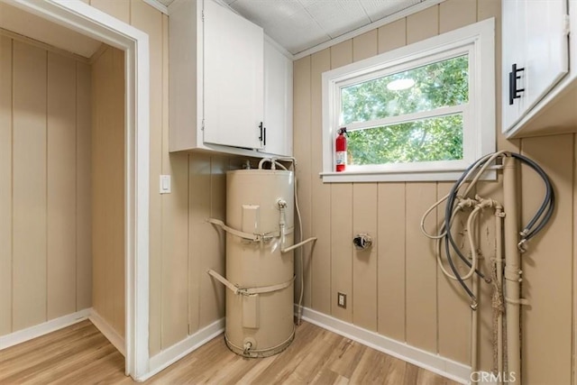 1212 N Old Stage Rd, Mount Shasta, CA 96067 - laundry area with light wood-style flooring, cabinet space, and water heater