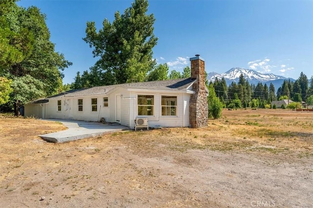 1212 N Old Stage Rd, Mount Shasta, CA 96067 - back of house featuring a chimney, a patio, and a mountain view