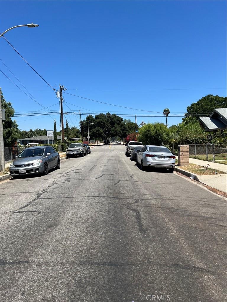 246 E 12th St, Pomona, CA 91766 - view of asphalt street featuring curbs, sidewalks, and street lights
