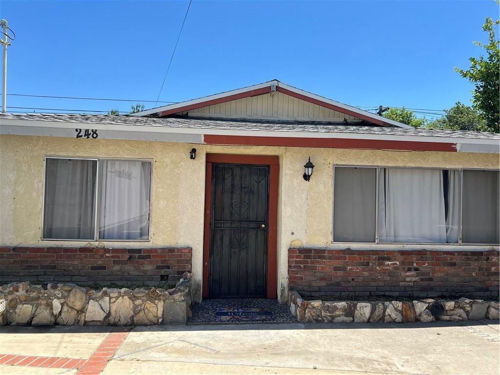 246 E 12th St, Pomona, CA 91766 - property entrance with brick siding and stucco siding