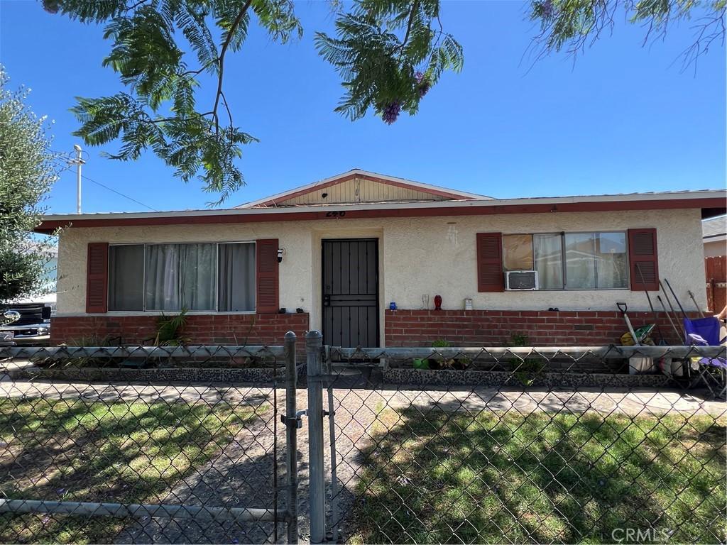 246 E 12th St, Pomona, CA 91766 - view of front of house with a fenced front yard, stucco siding, and brick siding
