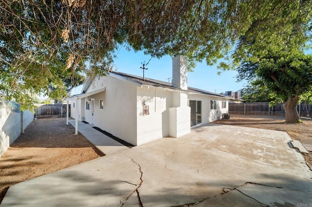 11233 Mountain, Riverside, CA 92505 - rear view of house featuring stucco siding, a chimney, a patio, and a fenced backyard