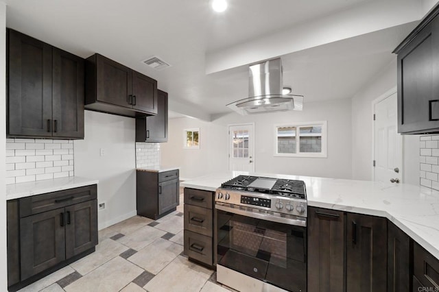 11233 Mountain, Riverside, CA 92505 - kitchen with stainless steel gas range oven, island range hood, decorative backsplash, and light stone counters