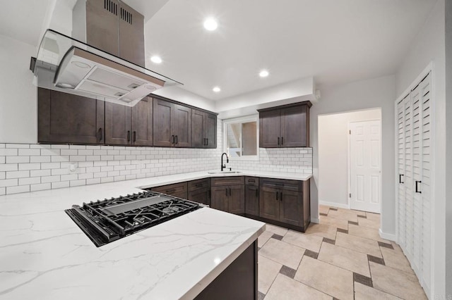 11233 Mountain, Riverside, CA 92505 - kitchen with ventilation hood, black cooktop, tasteful backsplash, dark brown cabinets, and light stone countertops