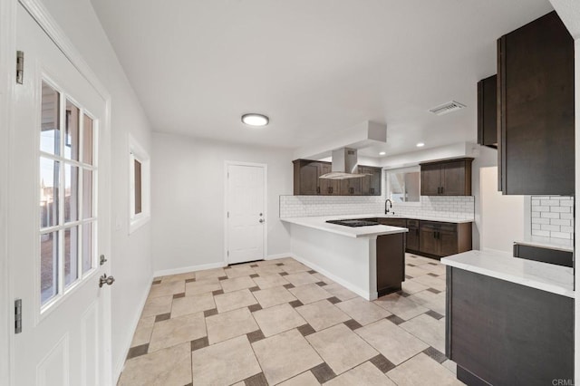 11233 Mountain, Riverside, CA 92505 - kitchen with island exhaust hood, tasteful backsplash, dark brown cabinets, a peninsula, and light countertops