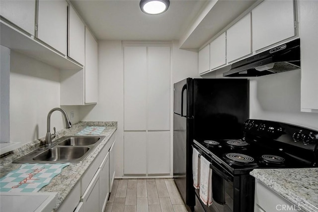 23318 Sesame St Unit E, Torrance, CA 90502 - kitchen featuring black range with electric stovetop, under cabinet range hood, wood tiled floors, and white cabinets