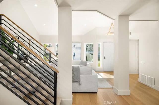 11 Thunder Trl Unit 6, Irvine, CA 92614 - living area featuring high vaulted ceiling, stairs, and wood finished floors