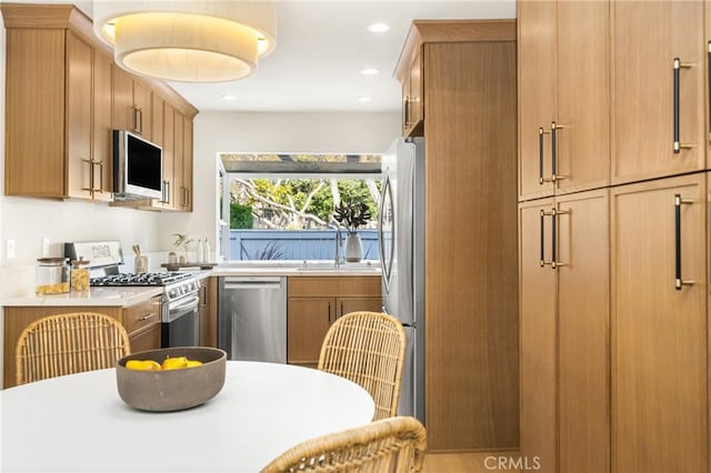11 Thunder Trl Unit 6, Irvine, CA 92614 - kitchen featuring appliances with stainless steel finishes, light countertops, recessed lighting, and brown cabinetry