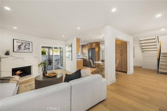 11 Thunder Trl Unit 6, Irvine, CA 92614 - living area with stairs, light wood-style flooring, recessed lighting, and a fireplace