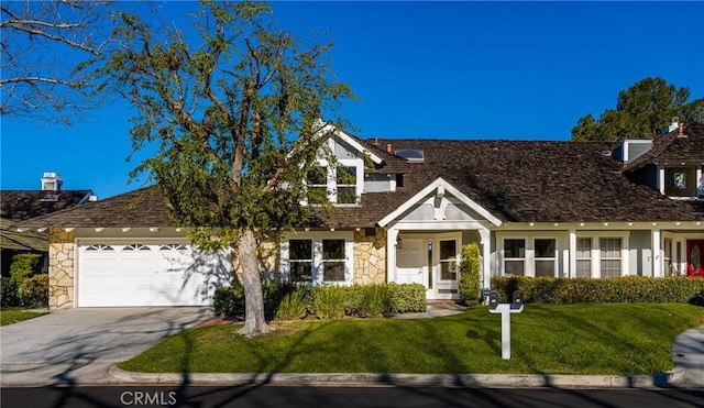 11 Thunder Trl Unit 6, Irvine, CA 92614 - view of front facade with stone siding, concrete driveway, an attached garage, and a front yard