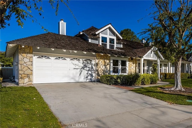 11 Thunder Trl Unit 6, Irvine, CA 92614 - view of front of house featuring stone siding, a garage, driveway, and a chimney