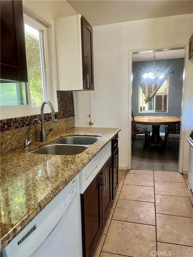 5617 29th St, Jurupa Valley, CA 92509 - kitchen featuring dishwasher, light stone countertops, dark brown cabinetry, decorative backsplash, and a chandelier
