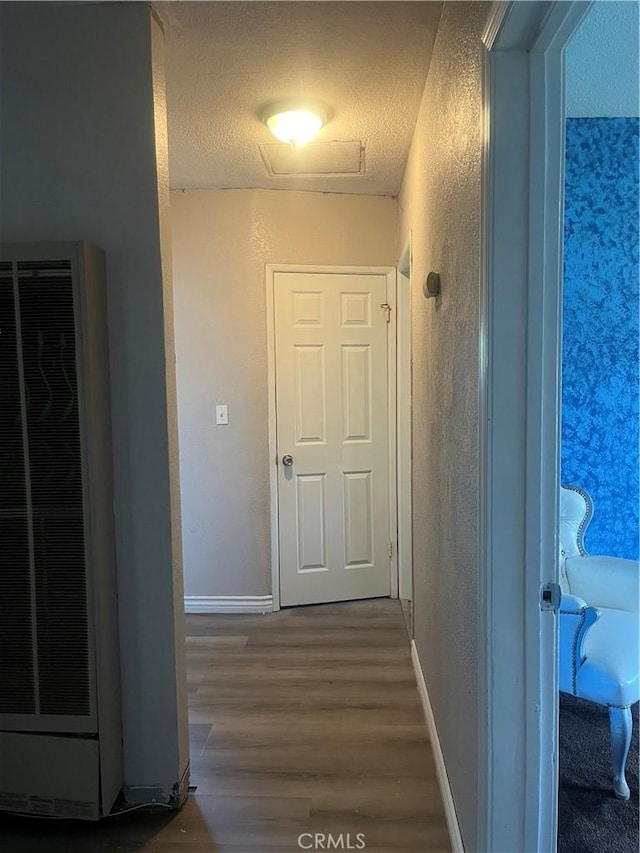 5617 29th St, Jurupa Valley, CA 92509 - hall with a heating unit, wood finished floors, a textured ceiling, and a textured wall