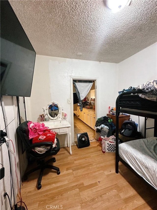 3747 Mintern St, Jurupa Valley, CA 92509 - bedroom with wood finished floors, a textured ceiling, and an office area