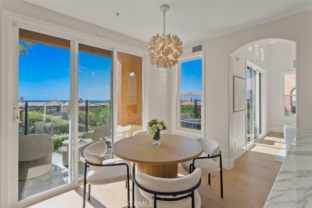 7 Suprema Dr, Newport Coast, CA 92657 - dining space featuring arched walkways, plenty of natural light, and a chandelier