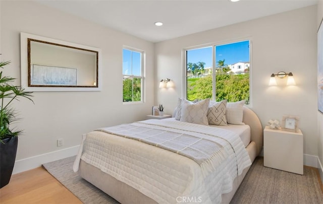 7 Suprema Dr, Newport Coast, CA 92657 - bedroom with multiple windows, wood finished floors, and recessed lighting