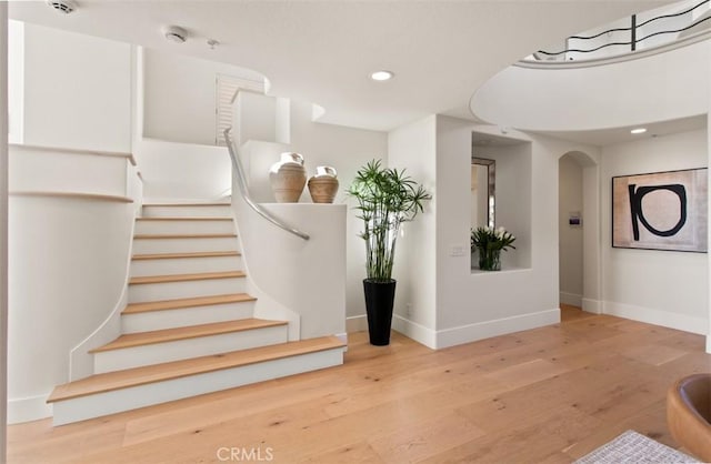 7 Suprema Dr, Newport Coast, CA 92657 - stairs with arched walkways, wood finished floors, and recessed lighting