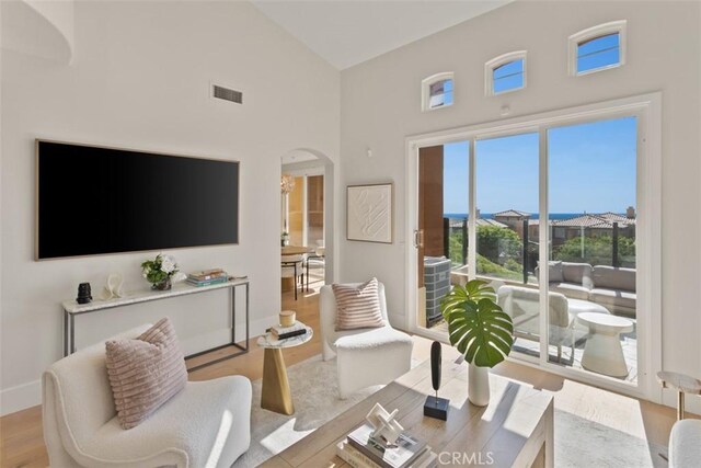 7 Suprema Dr, Newport Coast, CA 92657 - living area featuring high vaulted ceiling, arched walkways, and wood finished floors