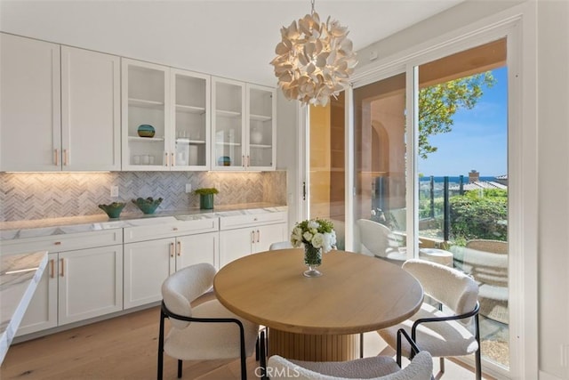 7 Suprema Dr, Newport Coast, CA 92657 - dining space featuring light wood finished floors and a chandelier