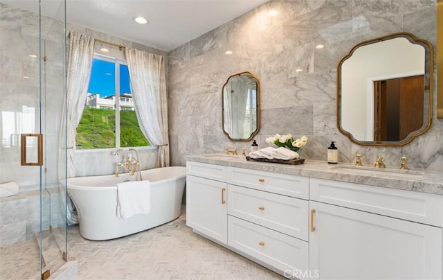 7 Suprema Dr, Newport Coast, CA 92657 - bathroom with double vanity, a shower stall, a freestanding tub, and tile walls
