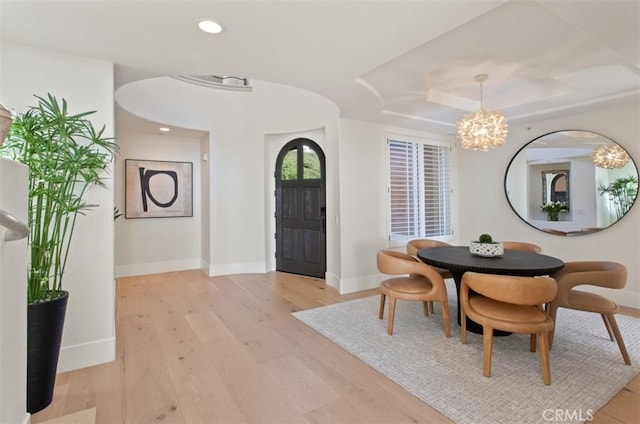 7 Suprema Dr, Newport Coast, CA 92657 - dining area featuring a chandelier, light wood-style flooring, recessed lighting, and a raised ceiling