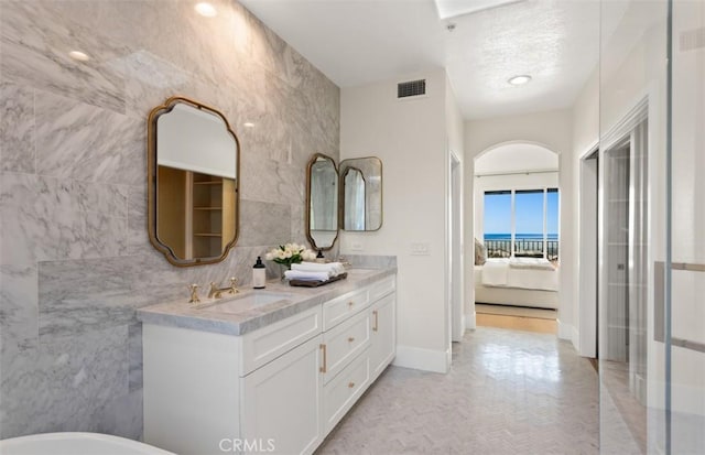 7 Suprema Dr, Newport Coast, CA 92657 - full bathroom with tile walls, double vanity, a freestanding bath, and ensuite bathroom