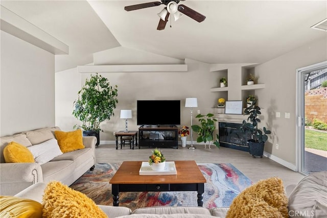 825 Rosana Pl, Nipomo, CA 93444 - living room featuring a ceiling fan, wood finished floors, vaulted ceiling, and a glass covered fireplace