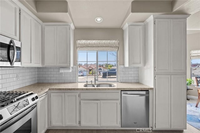 825 Rosana Pl, Nipomo, CA 93444 - kitchen with appliances with stainless steel finishes, white cabinetry, light stone counters, backsplash, and recessed lighting