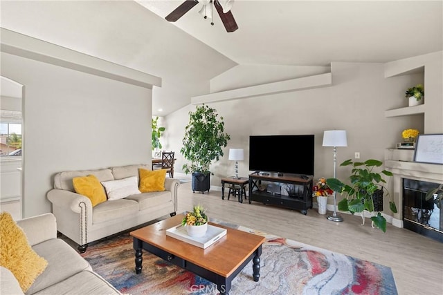 825 Rosana Pl, Nipomo, CA 93444 - living area featuring wood finished floors, ceiling fan, lofted ceiling, a glass covered fireplace, and arched walkways