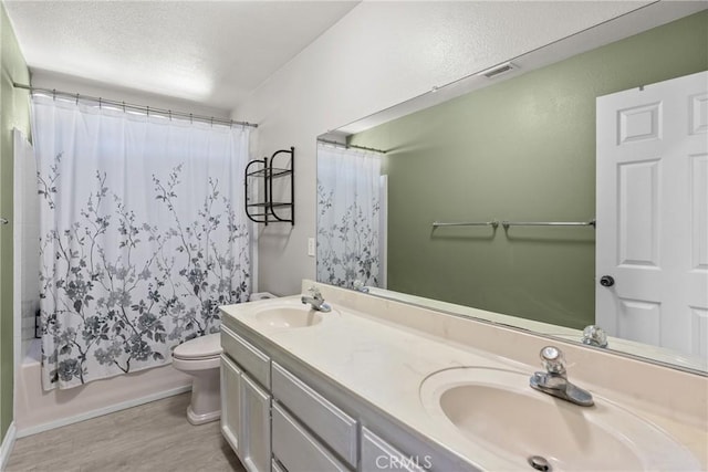825 Rosana Pl, Nipomo, CA 93444 - bathroom featuring double vanity, wood finished floors, shower / tub combo, and a textured ceiling