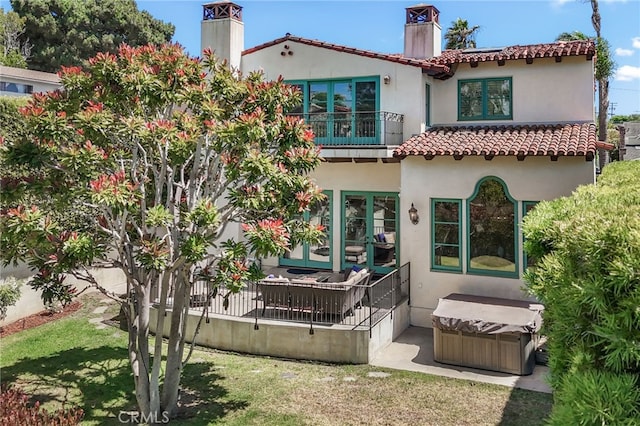 1337 8th St, Manhattan Beach, CA 90266 - rear view of house featuring a chimney, a hot tub, stucco siding, and a tiled roof