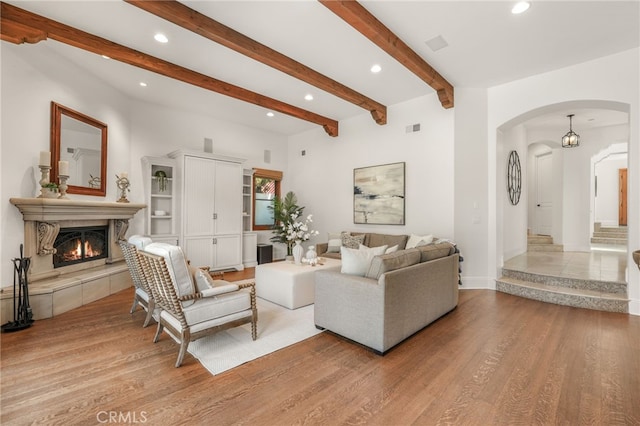 1337 8th St, Manhattan Beach, CA 90266 - living room featuring arched walkways, recessed lighting, light wood finished floors, a tiled fireplace, and beamed ceiling