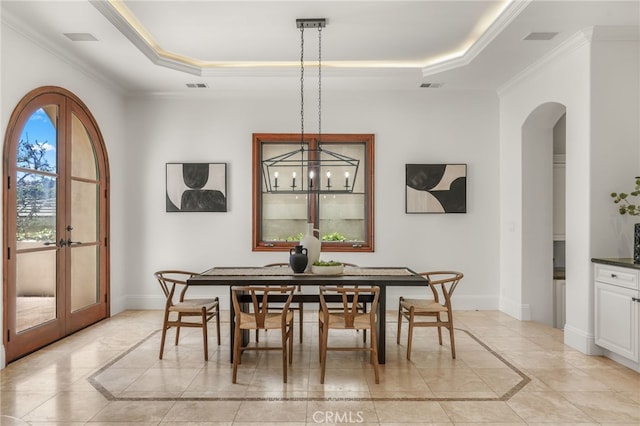 1337 8th St, Manhattan Beach, CA 90266 - dining area with inlaid floor details, a tray ceiling, arched walkways, crown molding, and light tile patterned floors