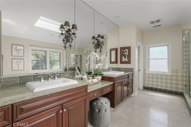 1337 8th St, Manhattan Beach, CA 90266 - bathroom featuring vanity, a skylight, a tile shower, tile patterned flooring, and a chandelier
