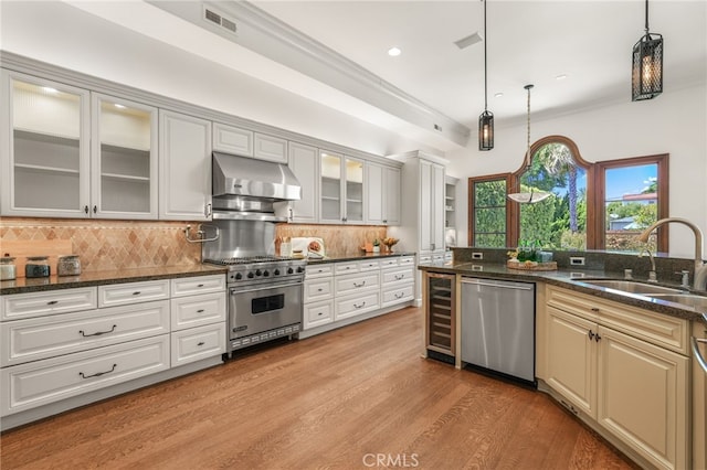 1337 8th St, Manhattan Beach, CA 90266 - kitchen with appliances with stainless steel finishes, exhaust hood, beverage cooler, tasteful backsplash, and light wood-style floors