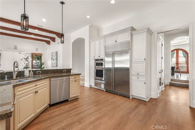 1337 8th St, Manhattan Beach, CA 90266 - kitchen with arched walkways, appliances with stainless steel finishes, a warming drawer, healthy amount of natural light, and recessed lighting