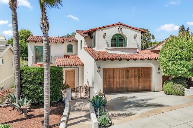 1337 8th St, Manhattan Beach, CA 90266 - mediterranean / spanish-style house featuring a tiled roof, stucco siding, driveway, a gate, and an attached garage