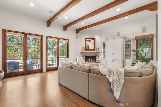 1337 8th St, Manhattan Beach, CA 90266 - living area with healthy amount of natural light, wood finished floors, a glass covered fireplace, recessed lighting, and beamed ceiling