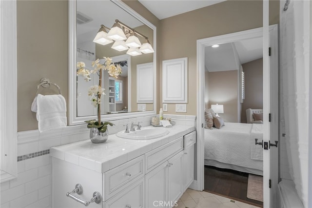 1337 8th St, Manhattan Beach, CA 90266 - full bathroom with vanity, connected bathroom, tile patterned floors, and a wainscoted wall