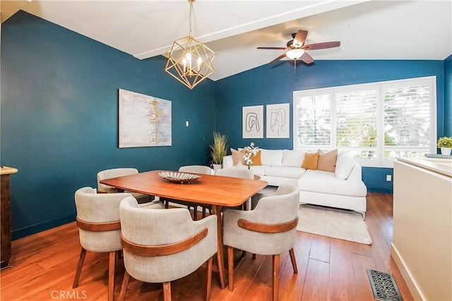 1002 Leighton Ave, Los Angeles, CA 90037 - dining room featuring hardwood / wood-style flooring, lofted ceiling, a chandelier, and ceiling fan