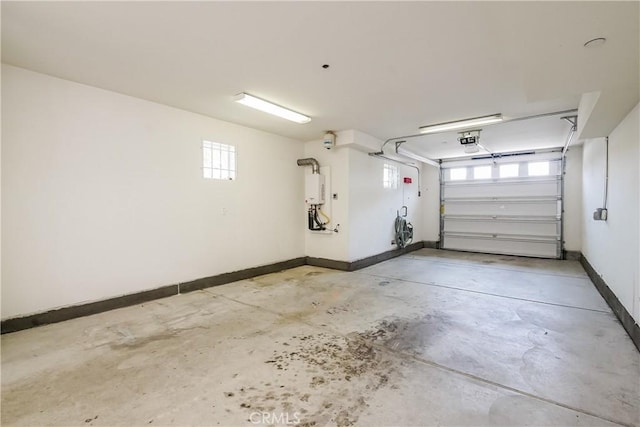 1002 Leighton Ave, Los Angeles, CA 90037 - garage featuring a garage door opener and baseboards