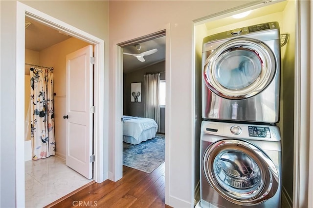 1002 Leighton Ave, Los Angeles, CA 90037 - washroom featuring stacked washer and clothes dryer and wood finished floors