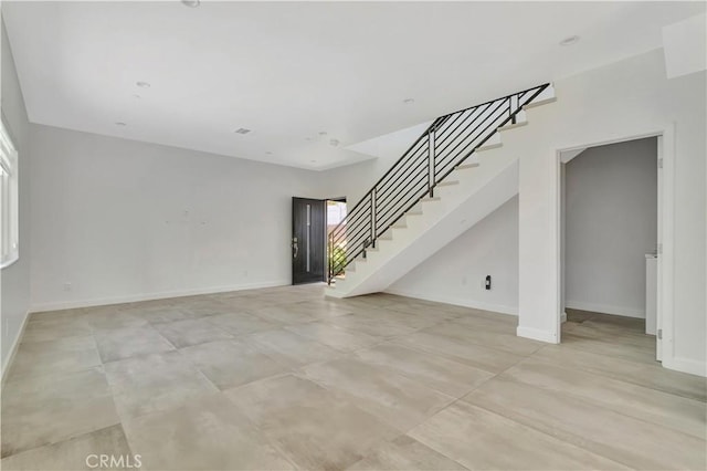 6943 Goodland Ave, North Hollywood, CA 91605 - unfurnished living room with stairs and healthy amount of natural light