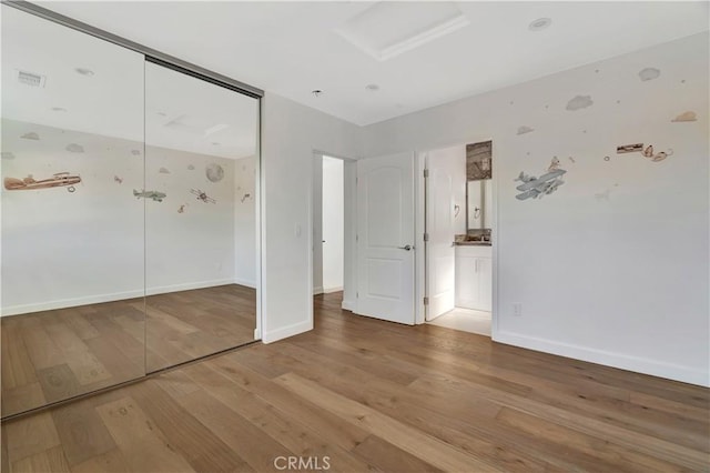 6943 Goodland Ave, North Hollywood, CA 91605 - unfurnished bedroom with wood finished floors, attic access, a closet, and ensuite bath