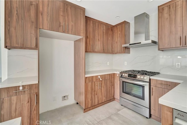 6943 Goodland Ave, North Hollywood, CA 91605 - kitchen featuring wall chimney range hood, stainless steel gas range, decorative backsplash, brown cabinets, and modern cabinets