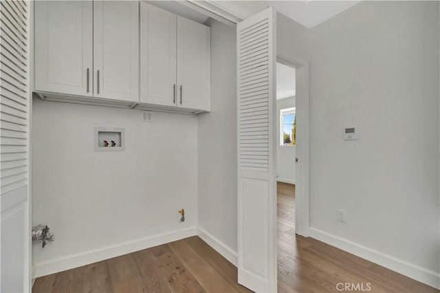 6943 Goodland Ave, North Hollywood, CA 91605 - washroom featuring cabinet space, wood finished floors, and hookup for a washing machine