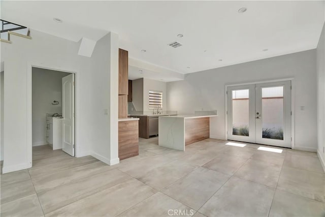 6943 Goodland Ave, North Hollywood, CA 91605 - kitchen featuring light countertops, french doors, dishwasher, modern cabinets, and brown cabinets