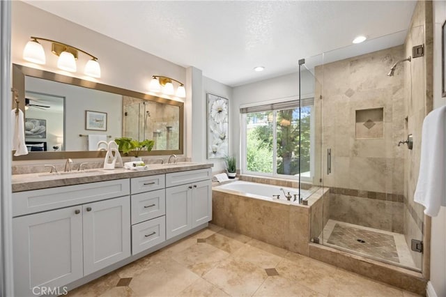 18 Via Tigra, Rancho Santa Margarita, CA 92688 - bathroom with a shower stall, a bath, double vanity, a ceiling fan, and tile patterned flooring